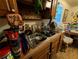 Kitchen sink and counter with wooden cabinets, window, and shelf with glassware at 730 Citrus St, Orlando, FL 32805