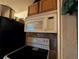 Kitchen features a stove and microwave oven with tiled backsplash at 730 Citrus St, Orlando, FL 32805