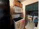Kitchen with stove, microwave, and black refrigerator, with a laundry area in the background at 730 Citrus St, Orlando, FL 32805