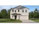 Charming two-story home featuring a two-car garage, beautifully landscaped front yard, and neutral-toned facade at 1345 Acorn Meadow Loop, Eustis, FL 32726