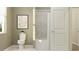 Bright bathroom featuring a white toilet, framed picture, and a shower with white tiling at 2179 Rider Rain Ln, Apopka, FL 32703