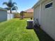 Well-maintained backyard featuring lush green grass and a modern AC unit at 6030 Dijulio Ter, The Villages, FL 32163