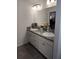 Bathroom featuring double sinks, granite countertops, and updated fixtures at 6030 Dijulio Ter, The Villages, FL 32163
