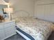 Bright bedroom with white furniture, floral bedding, and ample closet space at 6030 Dijulio Ter, The Villages, FL 32163