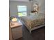 Bedroom featuring a desk, dresser, and bed with a view of the backyard at 6030 Dijulio Ter, The Villages, FL 32163