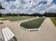 Bocce ball courts with lush green turf, surrounded by walking paths and benches at 6030 Dijulio Ter, The Villages, FL 32163