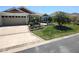 Exterior view of the home showcasing a paved driveway and well-maintained landscaping at 6030 Dijulio Ter, The Villages, FL 32163