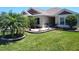 Charming home featuring lush lawn, mature landscaping, and a well-manicured front yard at 6030 Dijulio Ter, The Villages, FL 32163
