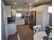 Well-lit kitchen features stainless steel appliances, granite countertops, and hardwood floors at 6030 Dijulio Ter, The Villages, FL 32163