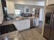 Modern kitchen with stainless steel appliances and granite countertops at 6030 Dijulio Ter, The Villages, FL 32163