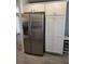 Kitchen featuring stainless steel refrigerator with white cabinets for storage at 6030 Dijulio Ter, The Villages, FL 32163