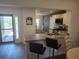Updated kitchen features granite countertops, stainless steel appliances, and a breakfast bar at 6030 Dijulio Ter, The Villages, FL 32163