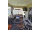 Screened lanai with comfortable seating, ceiling fan, and outdoor TV at 6030 Dijulio Ter, The Villages, FL 32163