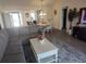 Inviting living room flows to dining and kitchen area, with hardwood floors at 6030 Dijulio Ter, The Villages, FL 32163