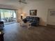 Comfortable living room with wood flooring and a sliding glass door to the lanai at 6030 Dijulio Ter, The Villages, FL 32163