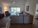 Spacious living room featuring a sectional sofa and access to the lanai at 6030 Dijulio Ter, The Villages, FL 32163