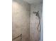 Modern shower with gray tiling, dual shower heads, and a convenient safety bar at 6030 Dijulio Ter, The Villages, FL 32163