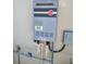 Rheem branded tankless water heater mounted to exterior wall at 6030 Dijulio Ter, The Villages, FL 32163
