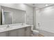 Bathroom features a double sink vanity and a shower and tub combination at 1620 Ellesmere Ave, Haines City, FL 33844