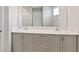Bathroom featuring double sinks with modern faucets, gray cabinetry, and ample counter space at 1620 Ellesmere Ave, Haines City, FL 33844