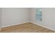 Neutral bedroom features wood-look floors and a bright window at 1620 Ellesmere Ave, Haines City, FL 33844