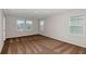This bedroom features three large windows that let in plenty of natural light and has plush brown carpet at 1620 Ellesmere Ave, Haines City, FL 33844