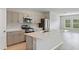 Bright kitchen features stainless appliances, stone countertops, and an island with a sink at 1620 Ellesmere Ave, Haines City, FL 33844