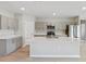 Modern kitchen with quartz countertops, gray cabinets, stainless steel appliances, and a large island sink at 1620 Ellesmere Ave, Haines City, FL 33844