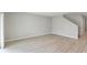 Spacious living room featuring light wood floors, white baseboards and a staircase at 1620 Ellesmere Ave, Haines City, FL 33844