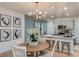 Open-concept dining area featuring modern chandelier and adjacent kitchen at 3823 King Hill Dr, Haines City, FL 33844