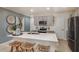 Bright kitchen with stainless steel appliances, quartz countertops, and island seating at 3823 King Hill Dr, Haines City, FL 33844