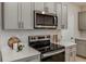 Close-up of the kitchen featuring stainless steel appliances and quartz countertops at 3823 King Hill Dr, Haines City, FL 33844