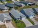 Aerial view of a well-maintained one story home with green lawn, an attached garage, and mature landscaping at 6229 Raven Run, Lakeland, FL 33809