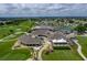 Aerial view of the golf course and community clubhouse, with tennis courts and surrounding neighborhood at 6229 Raven Run, Lakeland, FL 33809
