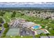 A beautiful aerial view of the community golf course, clubhouse, swimming pool, and tennis courts at 6229 Raven Run, Lakeland, FL 33809