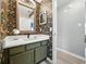 Stylish bathroom with colorful wallpaper, olive green vanity, white countertop, and modern fixtures at 6229 Raven Run, Lakeland, FL 33809