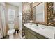 Bathroom featuring wallpaper, decorative mirror and single sink at 6229 Raven Run, Lakeland, FL 33809