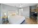 Bedroom with mirrored closet, side tables, ceiling fan and wood look flooring at 6229 Raven Run, Lakeland, FL 33809