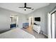 Spacious bedroom with wood-look floors, neutral walls, and an en-suite bathroom with a blue vanity at 6229 Raven Run, Lakeland, FL 33809