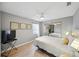 Bedroom with mirrored closet, ceiling fan, and light wood floor at 6229 Raven Run, Lakeland, FL 33809