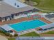 Aerial view of a large community pool with lounge chairs and a hot tub, perfect for relaxation and socializing at 6229 Raven Run, Lakeland, FL 33809