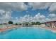 Inviting community pool featuring clear blue water and plenty of lounge chairs for relaxing and enjoying the outdoors at 6229 Raven Run, Lakeland, FL 33809