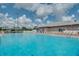 Spacious community pool area with ample seating, covered areas, and pristine blue water for relaxing swims at 6229 Raven Run, Lakeland, FL 33809
