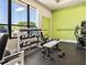 Weight room featuring dumbbells, benches, and large windows for natural light at 6229 Raven Run, Lakeland, FL 33809