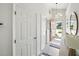 Bright entryway with modern light fixture, a charming mirror and a view to the exterior at 6229 Raven Run, Lakeland, FL 33809