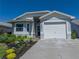 Charming home with manicured landscaping, a one-car garage, and a well-maintained front lawn at 6229 Raven Run, Lakeland, FL 33809