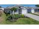 A charming one-story house with manicured landscaping, lush green lawn, and an attached garage at 6229 Raven Run, Lakeland, FL 33809