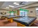 Game room with three billiard tables and green pendant lights at 6229 Raven Run, Lakeland, FL 33809