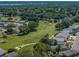 Aerial view of a golf course community with lush green fairways and manicured landscapes at 6229 Raven Run, Lakeland, FL 33809