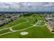 Scenic aerial view of the meticulously maintained golf course with lush green fairways at 6229 Raven Run, Lakeland, FL 33809